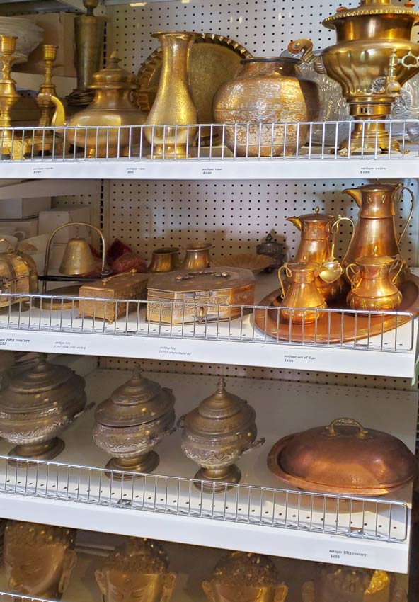 Sale at Lotus Market - Brass - Different brass decors on a shelf.